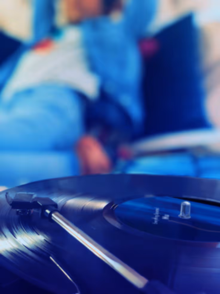 An image of young people grooving to the music playing via the record