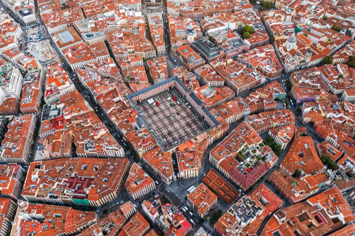 Aerial view of dense urban cityscape with interconnected buildings and streets