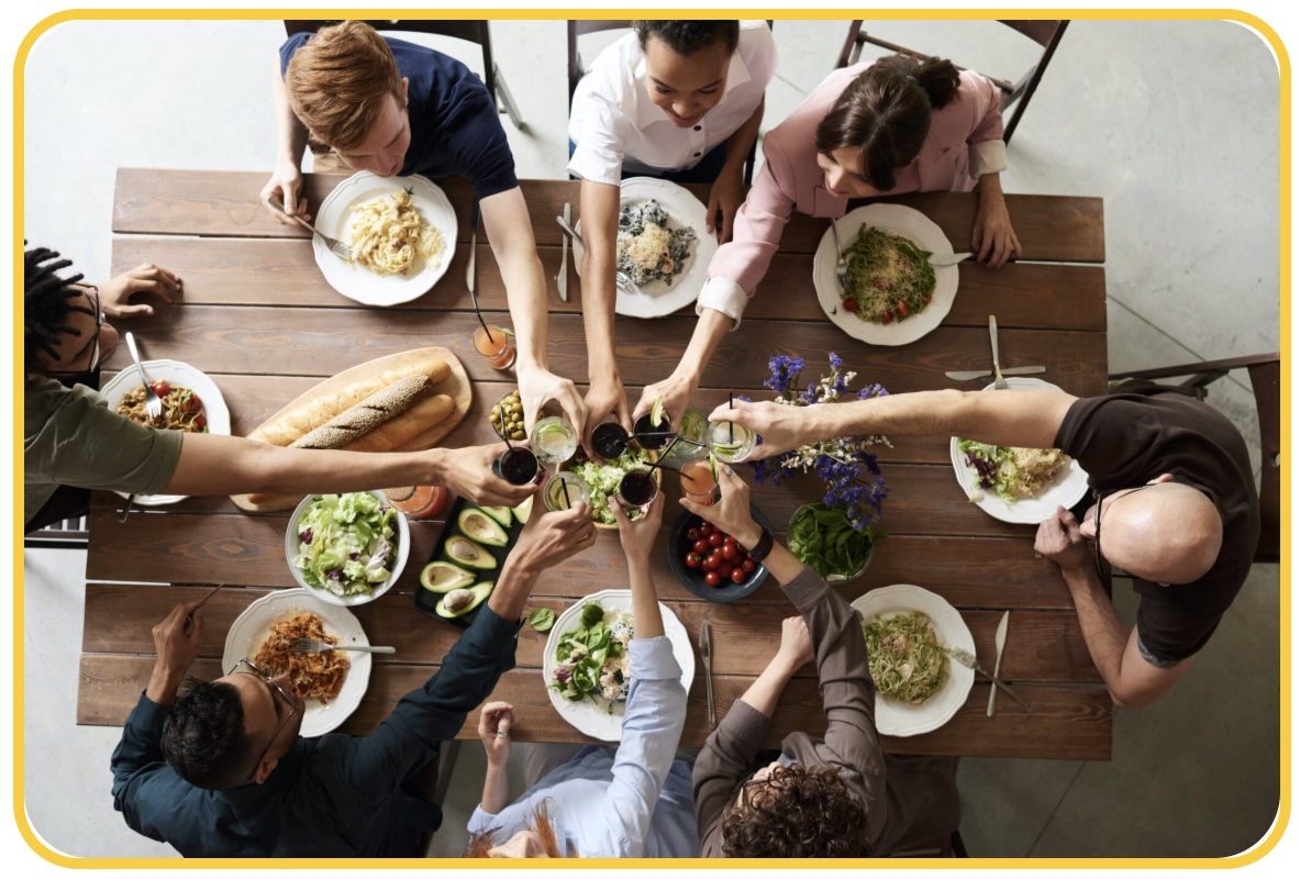 People sitting around the table eating and drinking