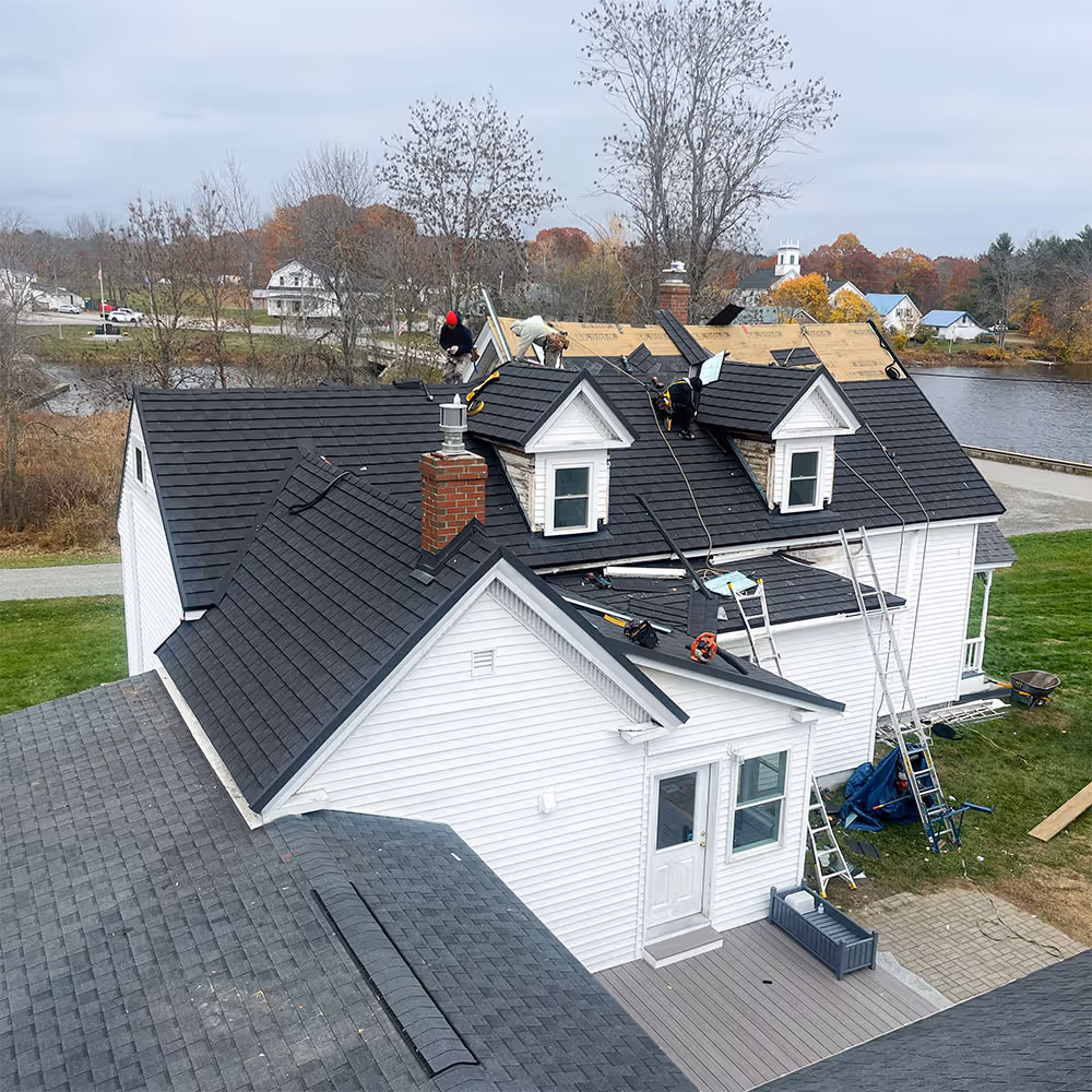 Close-up view of asphalt shingle roofing showing overlapping shingle pattern and texture.
