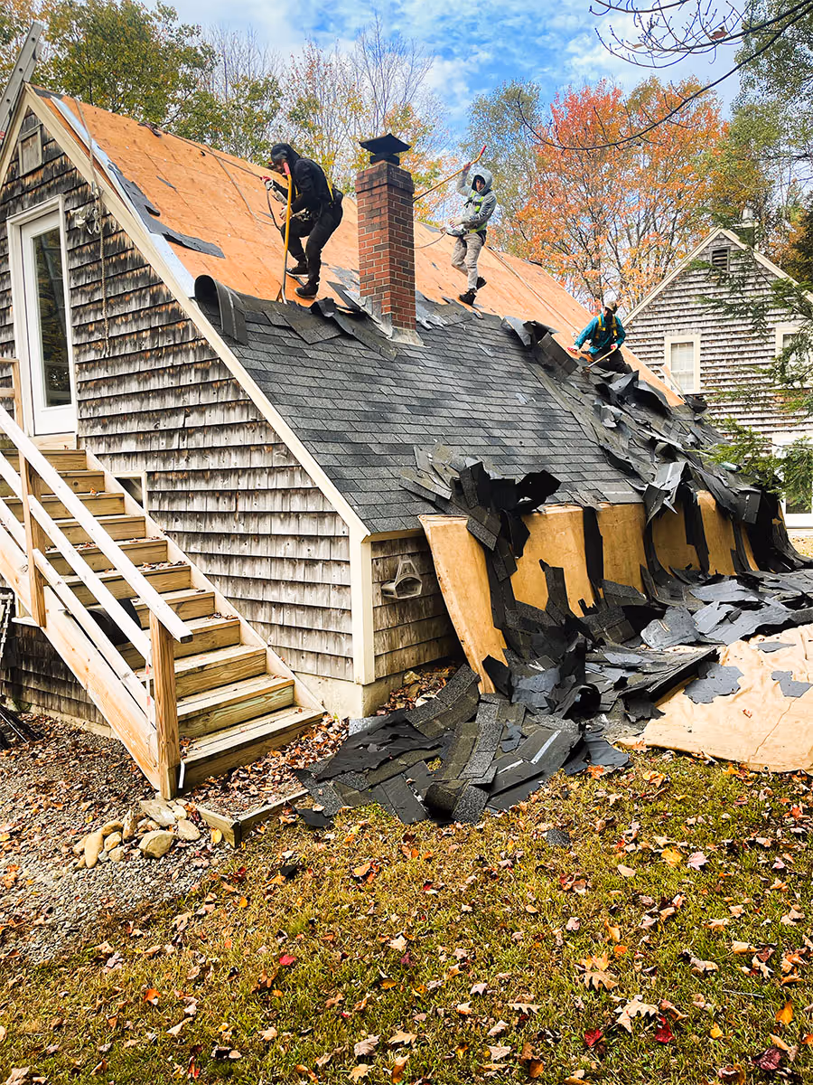 Completed shingle roof installation showing layered asphalt shingles on a residential home.