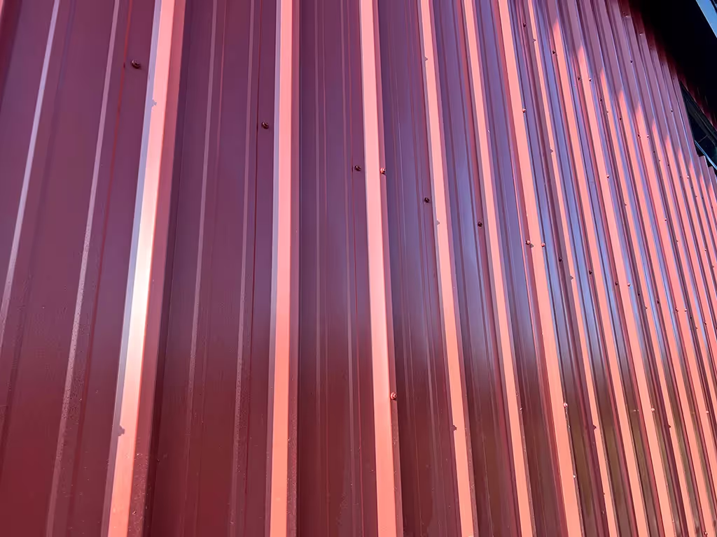 Commercial PBR metal roofing system installed on a large building structure.