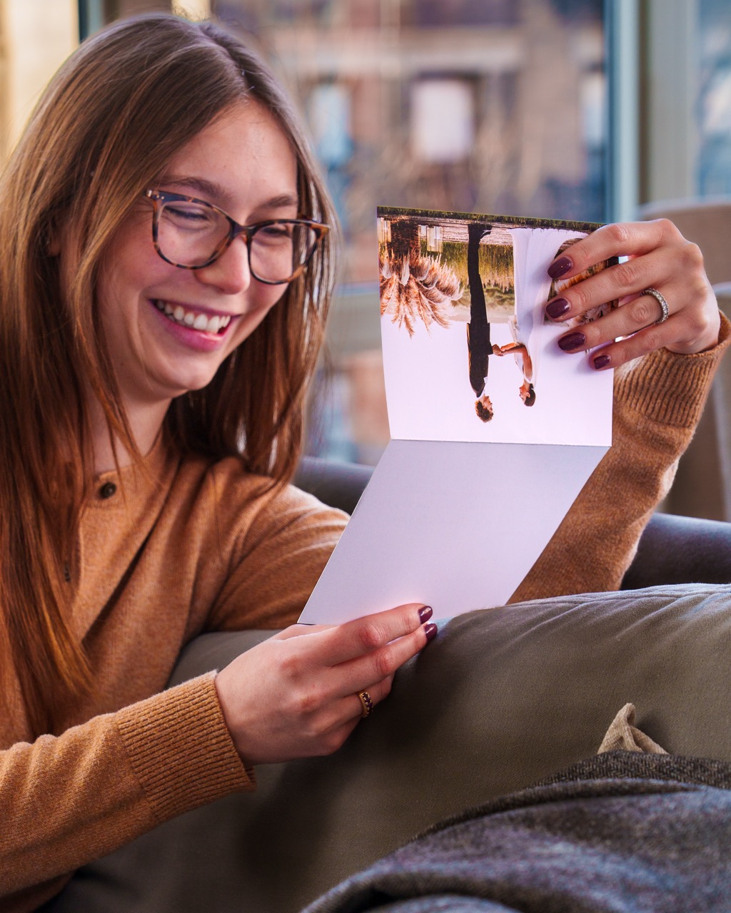 Customer smiling while reading a personalized photo card
