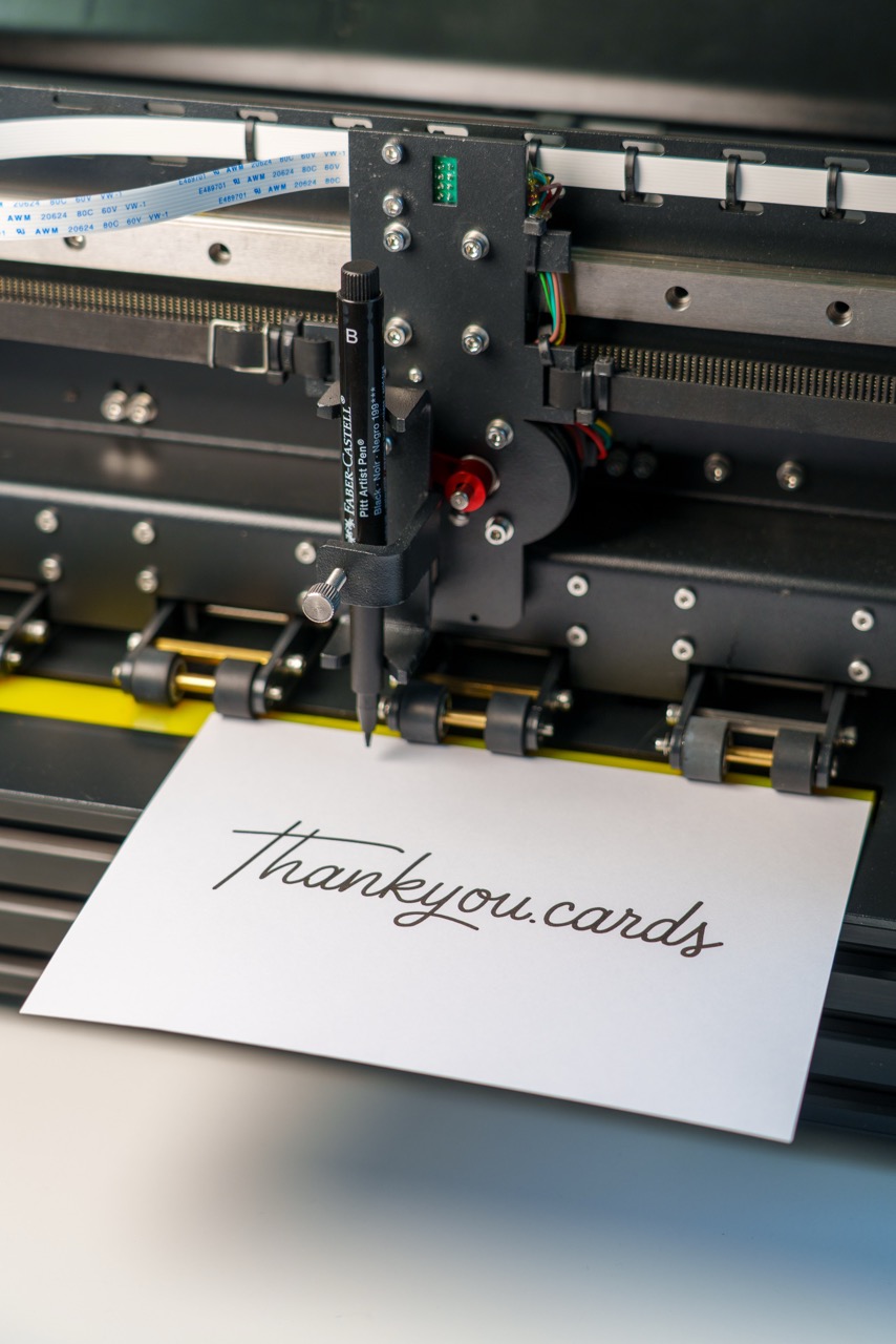 Pen plotter writing a card with real ink