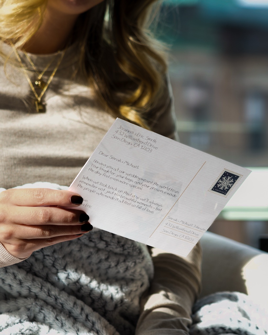 Handwritten postcard with a bold personalized message, held by a smiling recipient