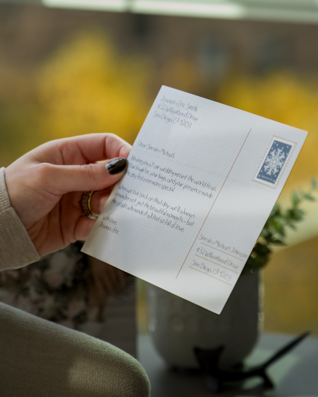 Recipient reading a handwritten card on a couch