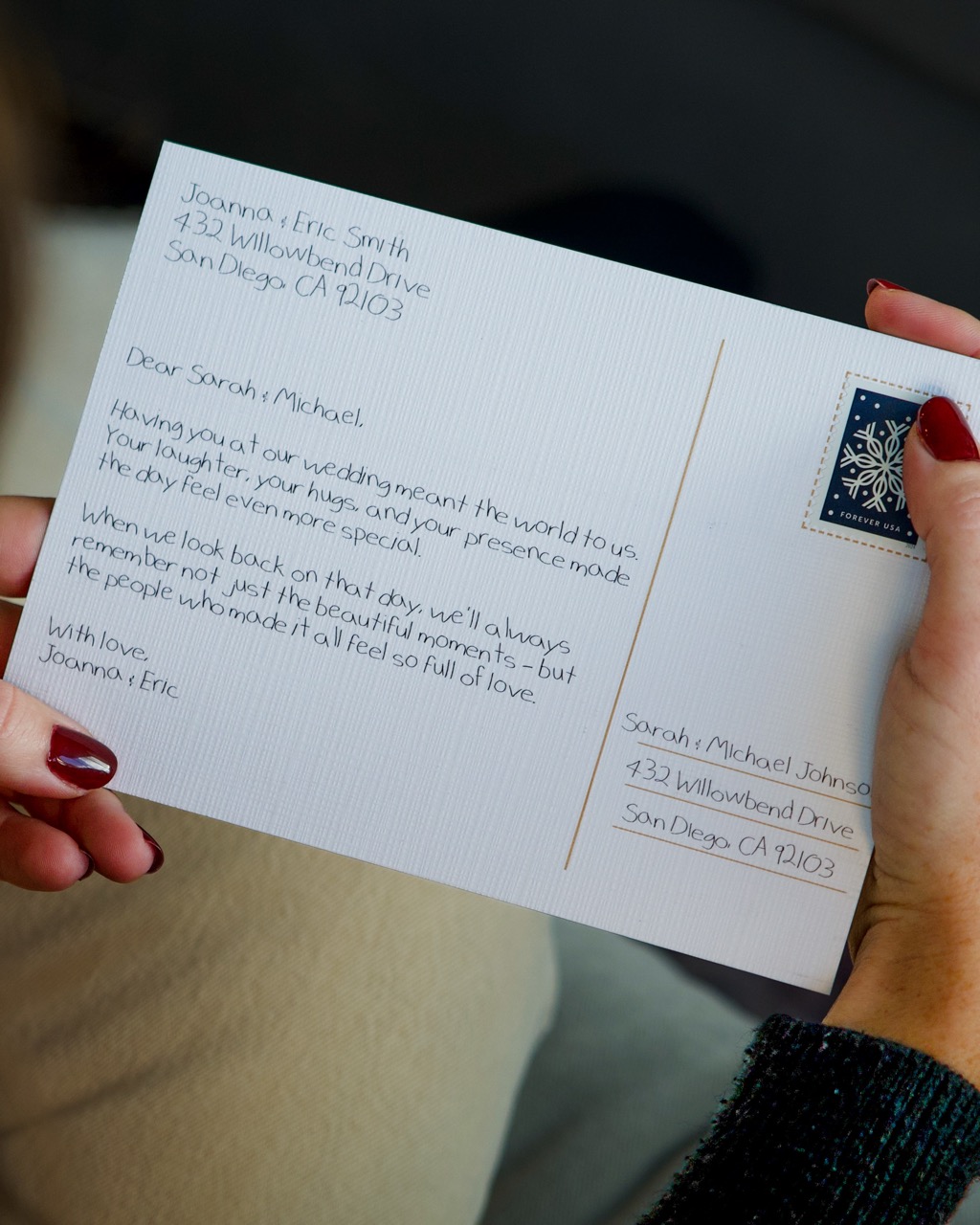Recipient reading a handwritten card on a couch