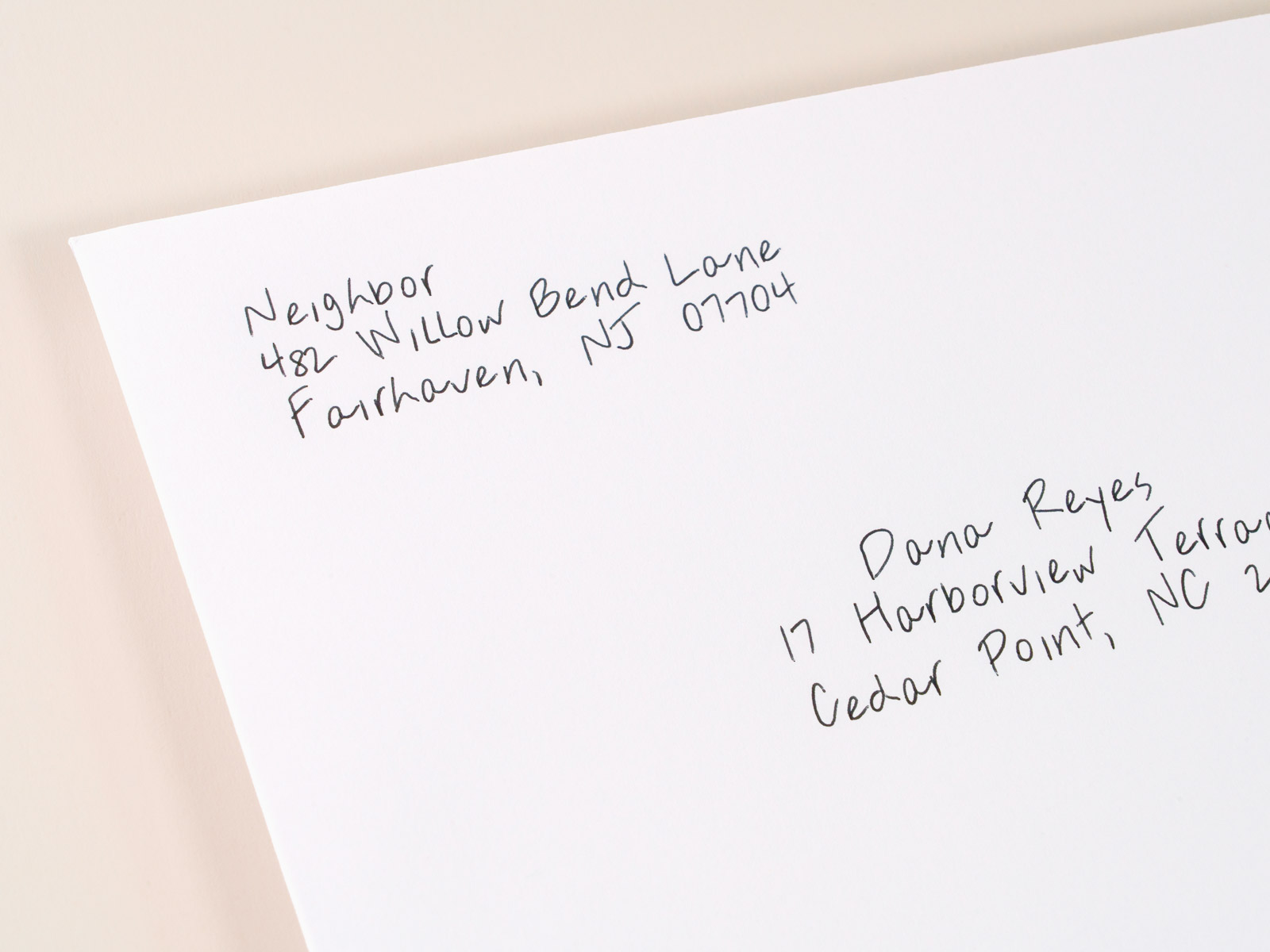 Macro close-up of a hand-addressed real estate envelope written in real pen