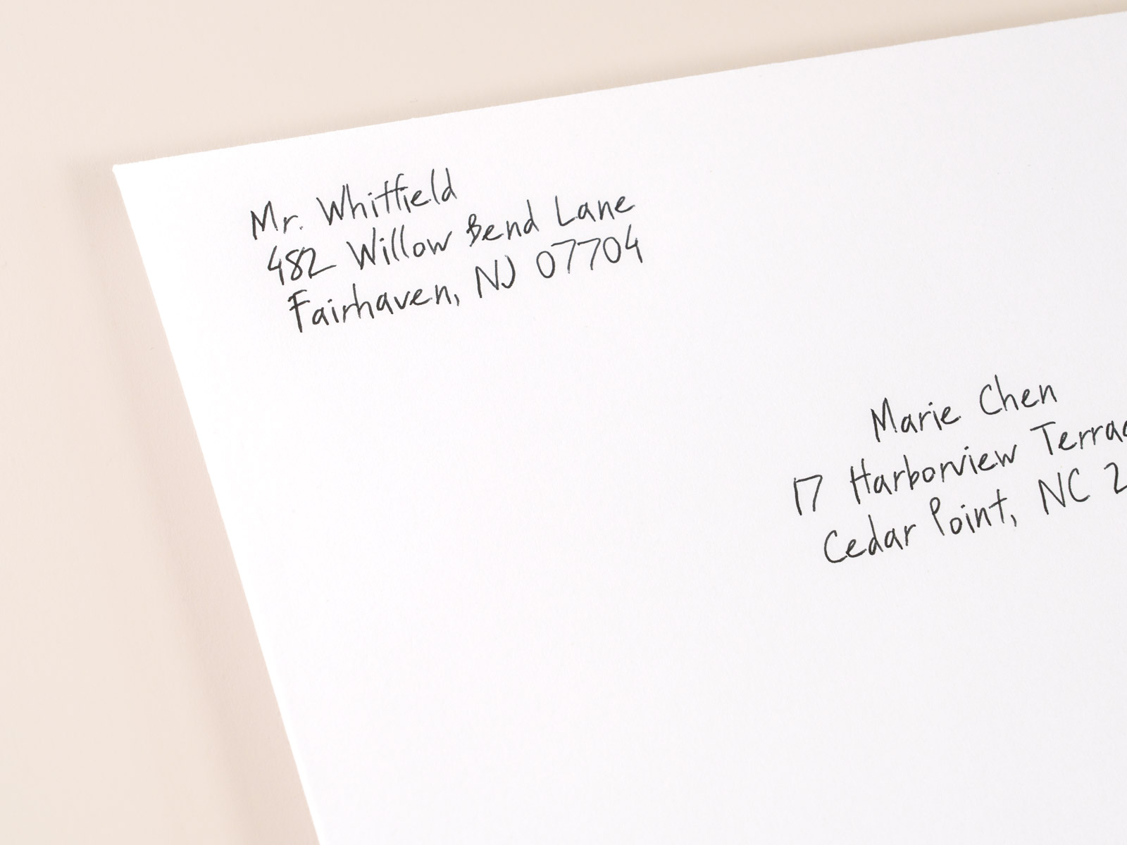 Macro close-up of a hand-addressed donor envelope written in real pen