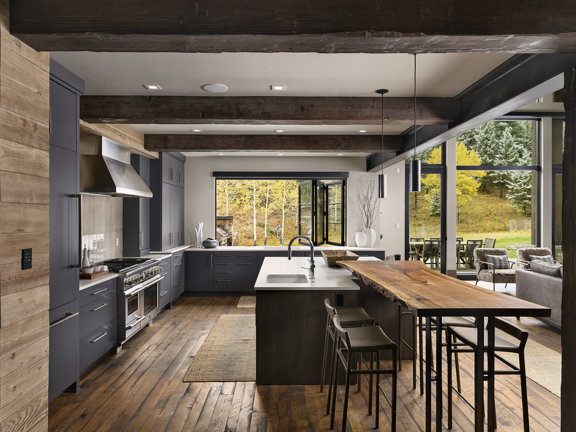 Handlebar Ranch kitchen with stone, steel, and reclaimed wood by Ejay Interiors
