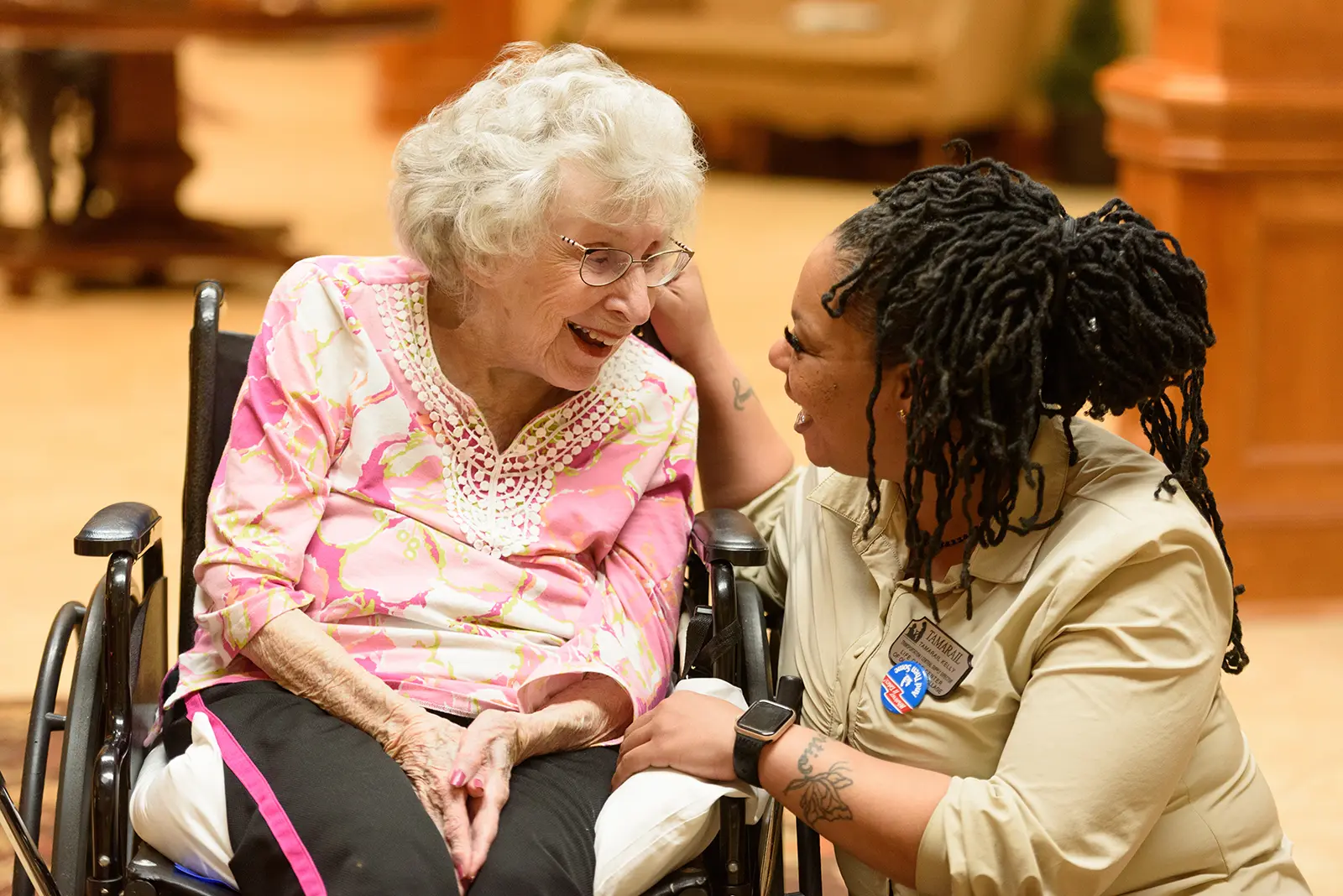 An associate shares a warm moment with a resident