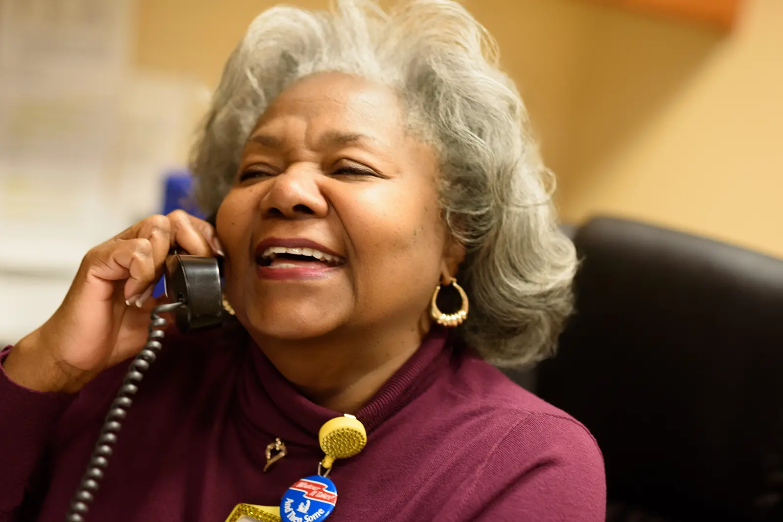 An associate laughs while answering the phone