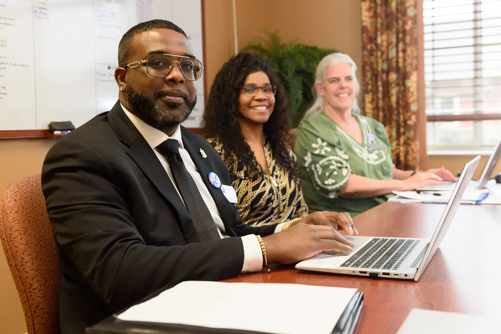 Team members smile around a conference table