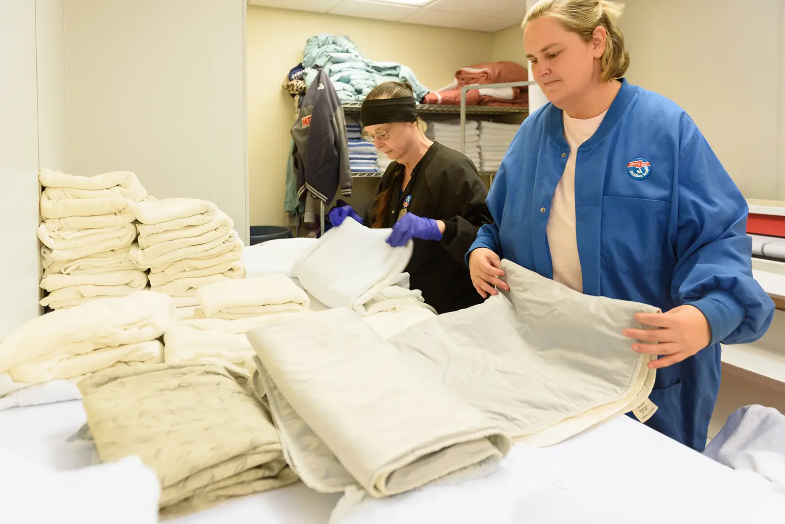 Laundry associates fold fresh linens