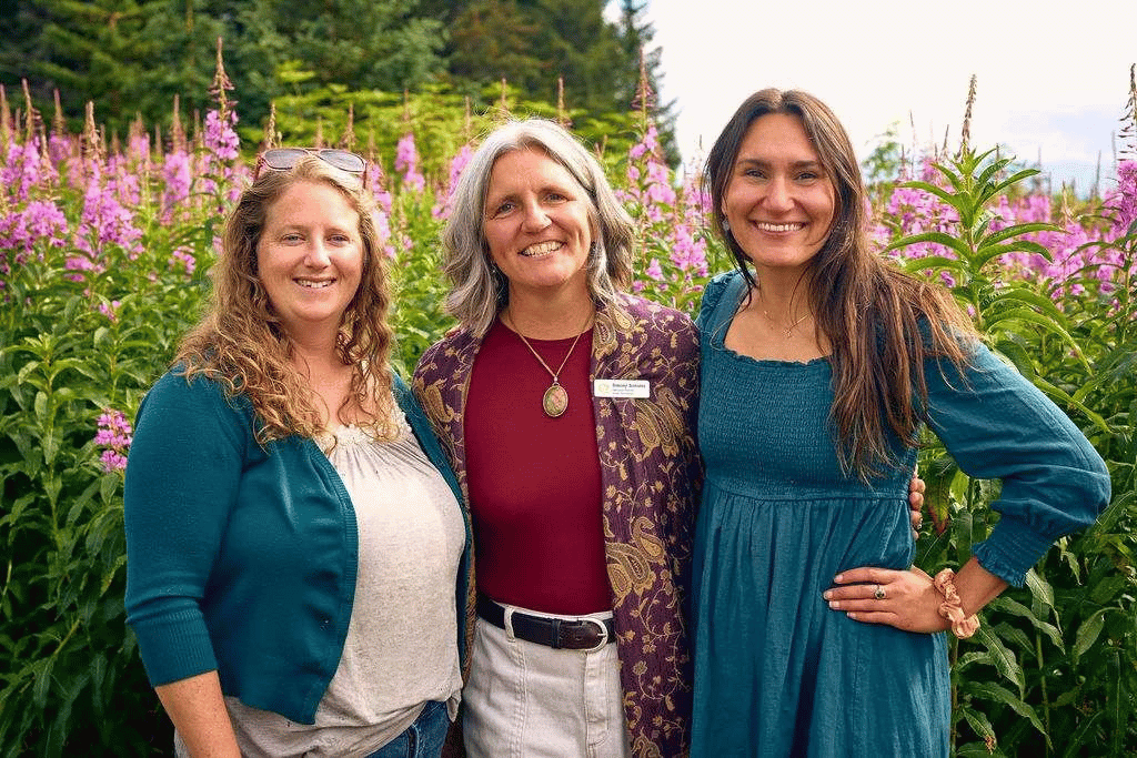 image of staff in front of a field of fireweed