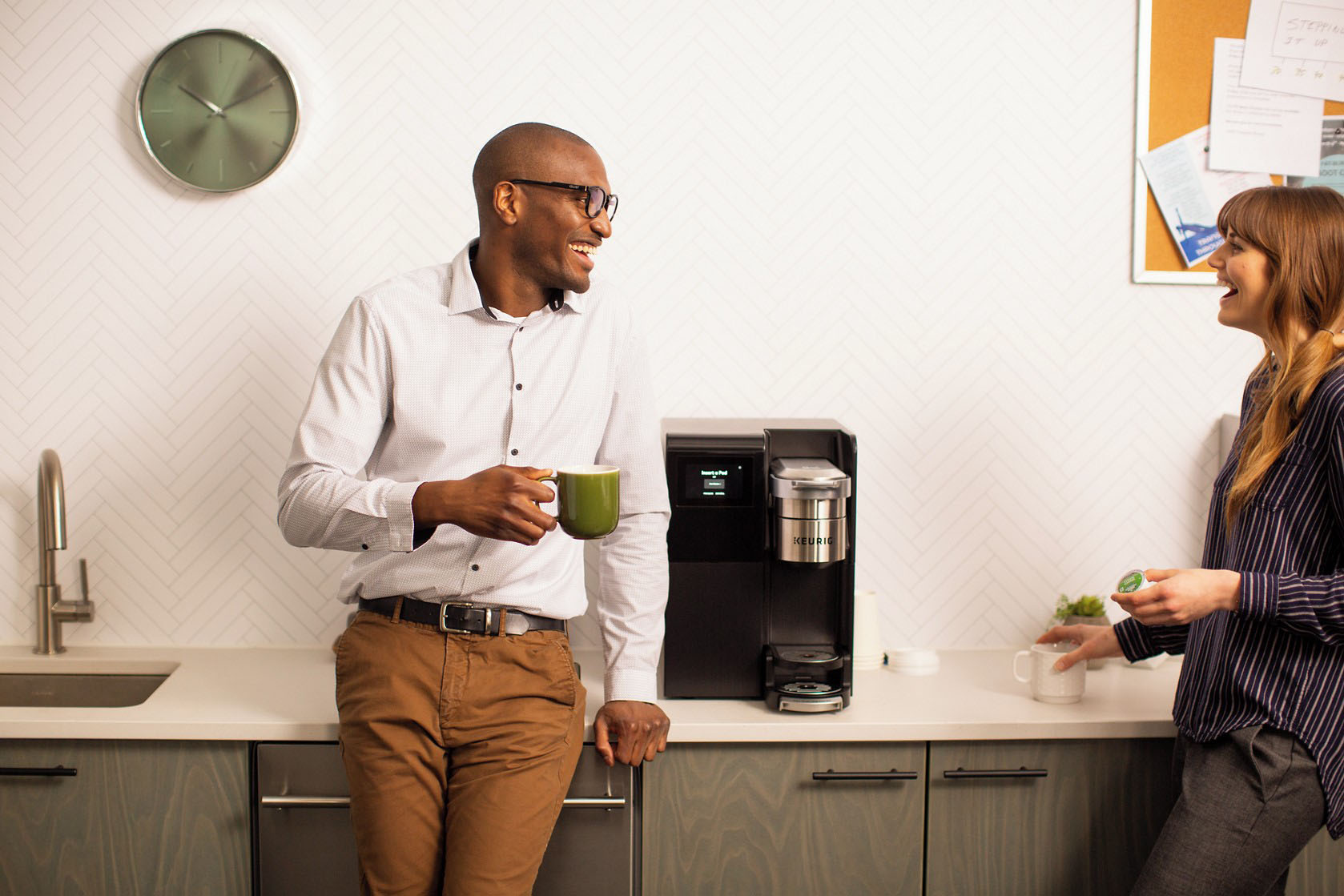 Coworkers beside an office coffee machine