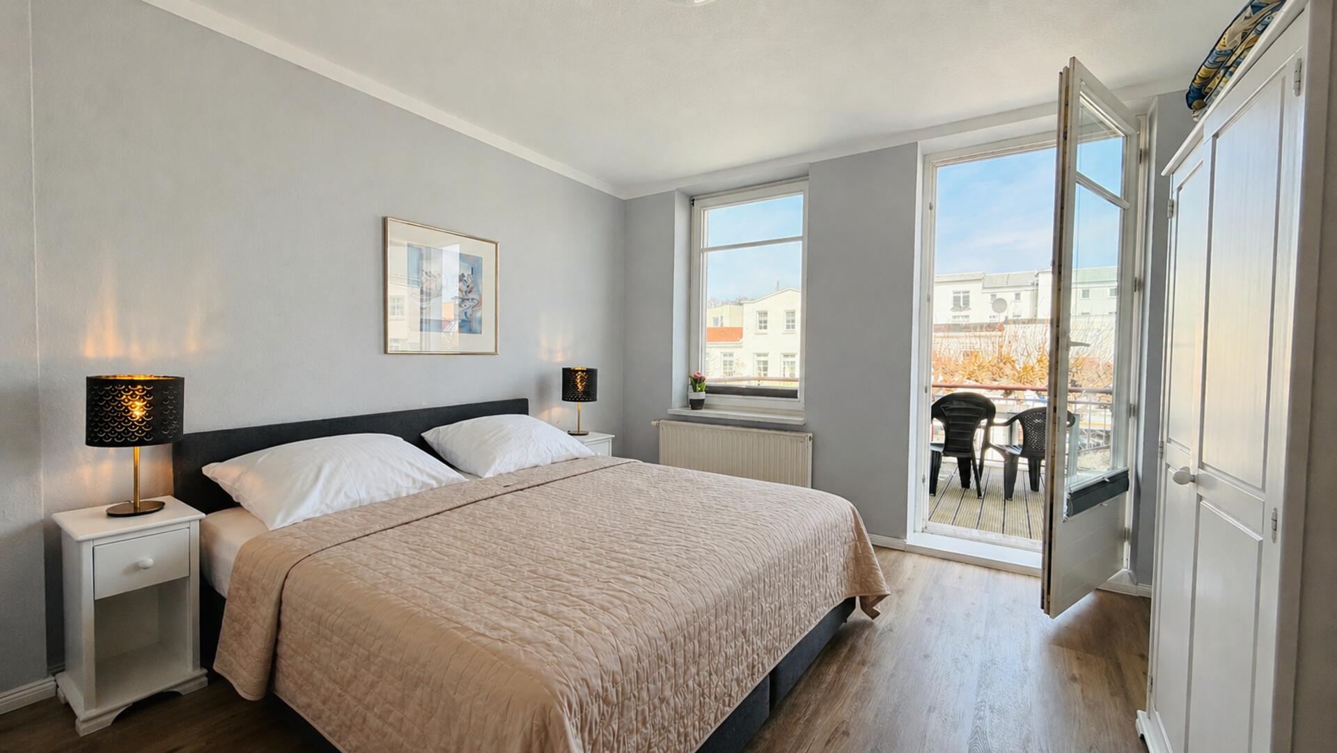 Wohnzimmer mit Couch und Essbereich und Blick auf den Balkon