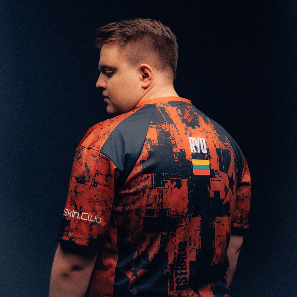 Person shown from the back wearing a red and black patterned shirt with RYU and a Lithuanian flag on it.