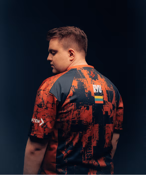 Person shown from the back wearing a red and black patterned shirt with RYU and a Lithuanian flag on it.