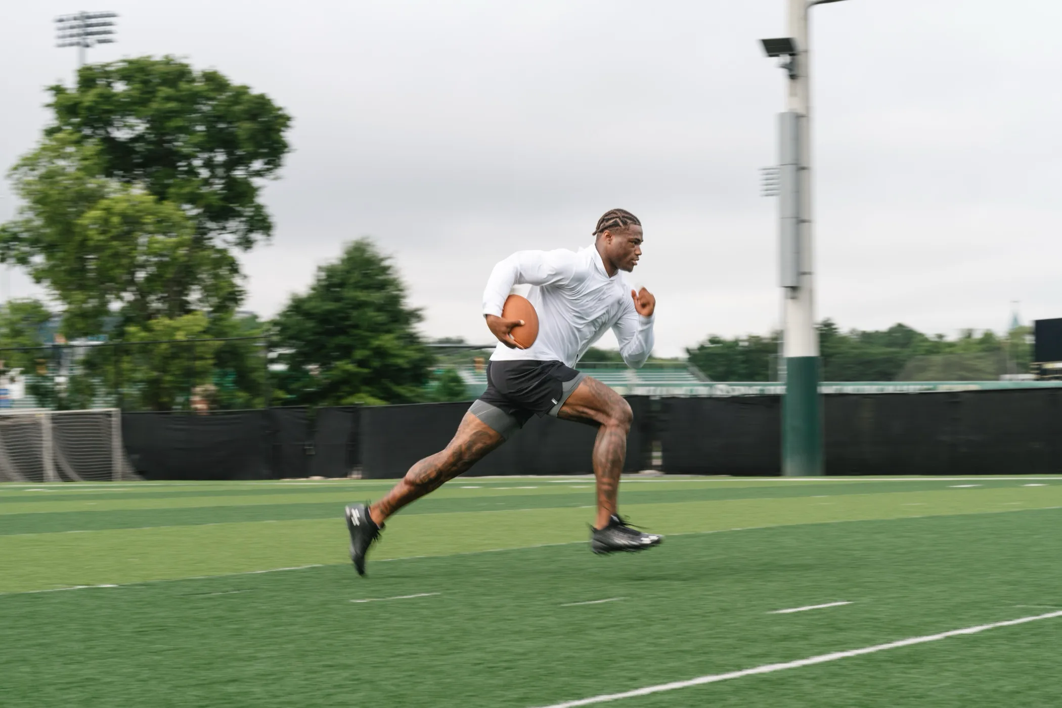 Athlete sprinting in Rhoback activewear
