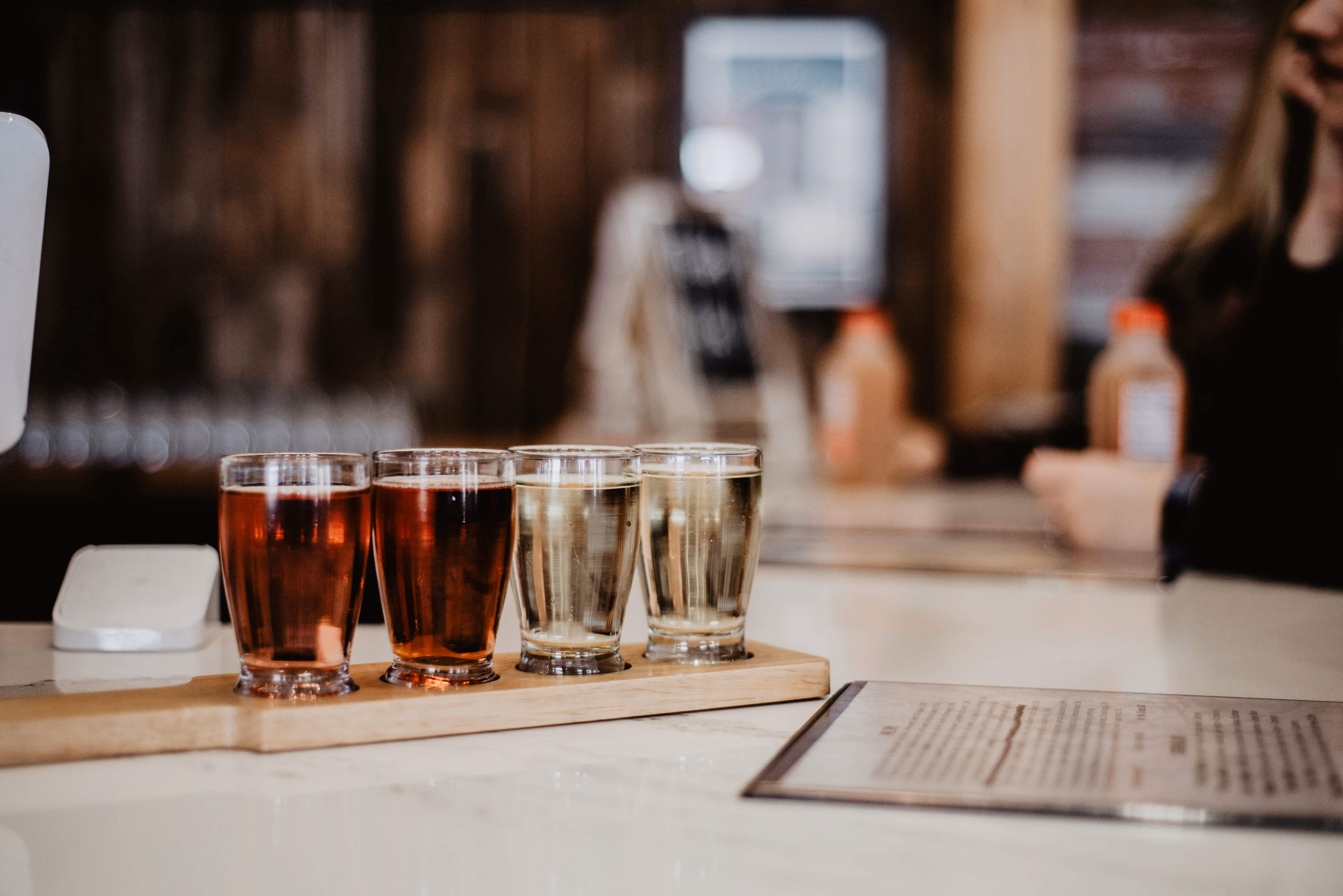 A flight of four cocktails at a bar