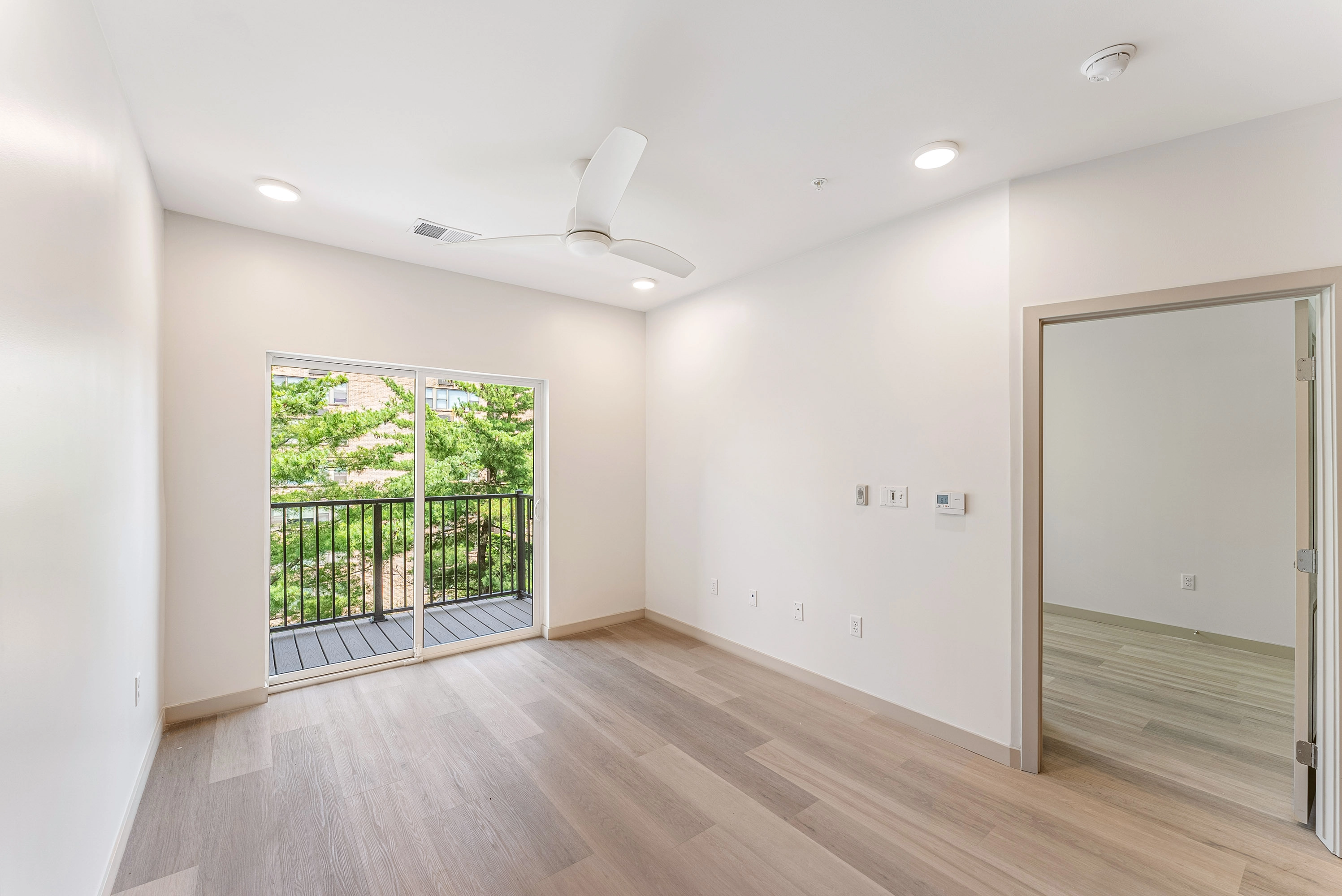 a living room with sliding glass doors that lead to a balcony