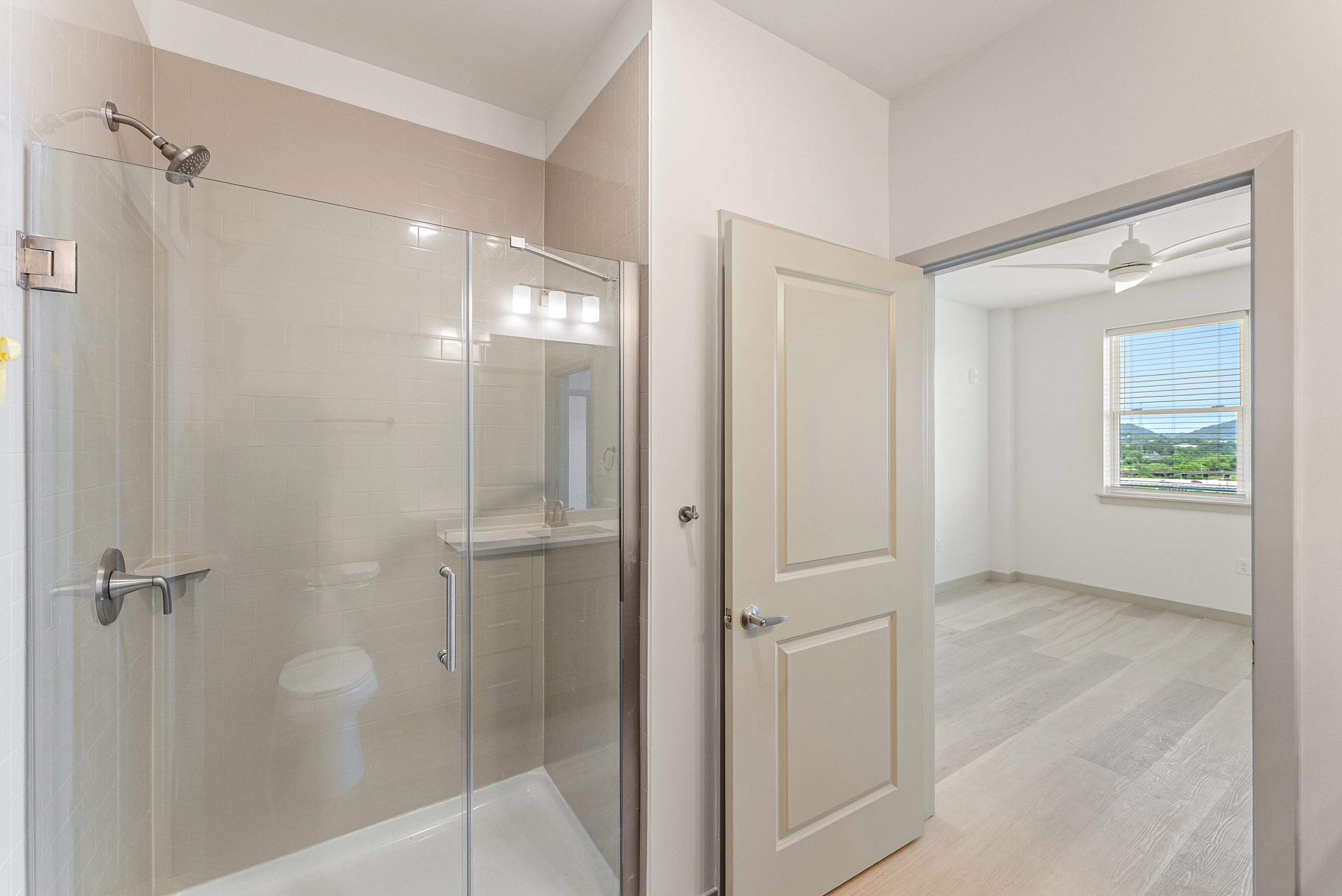 a bathroom with a shower that has a glass door