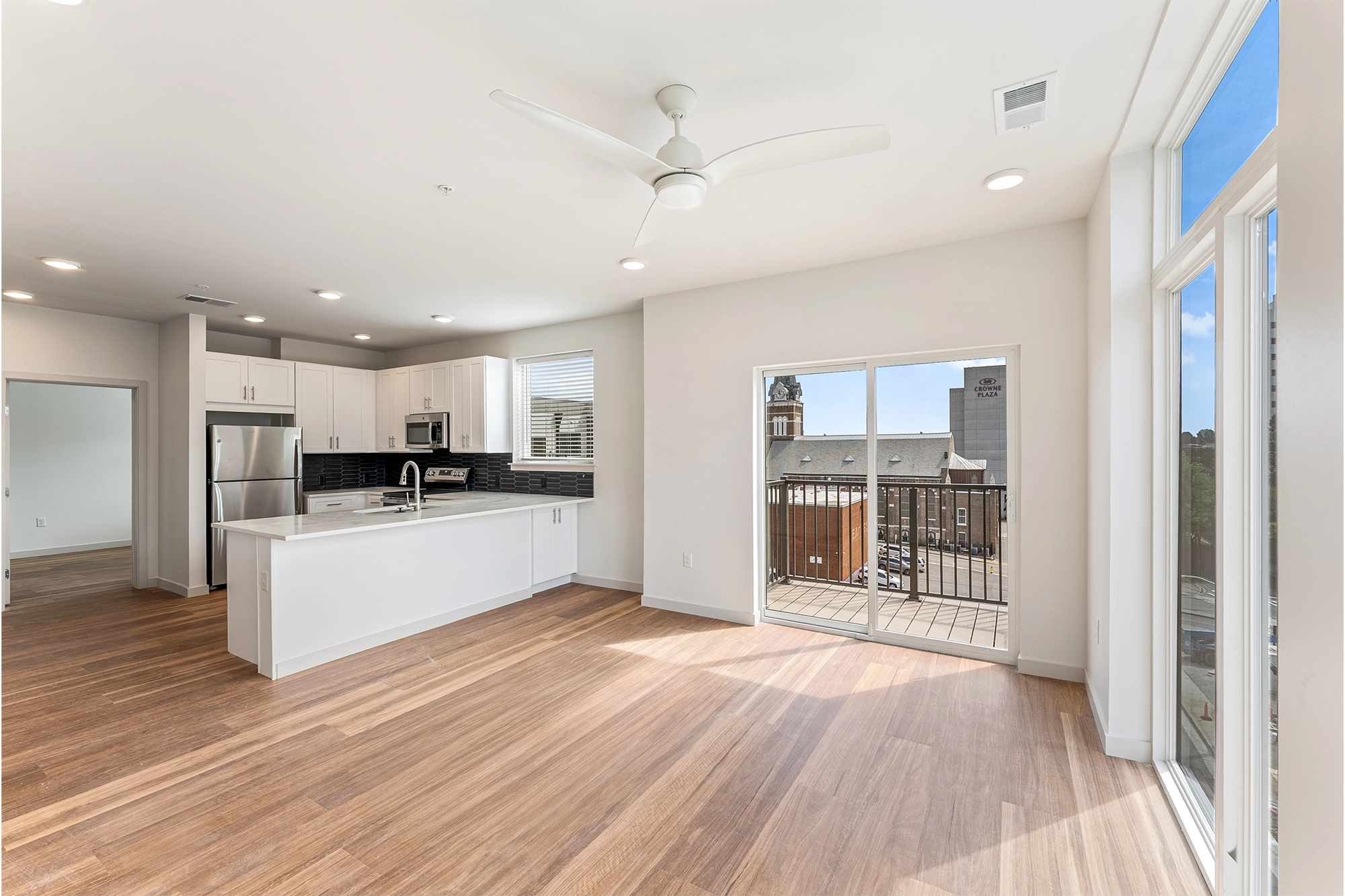 a living room with wooden floors over looking a balcony 