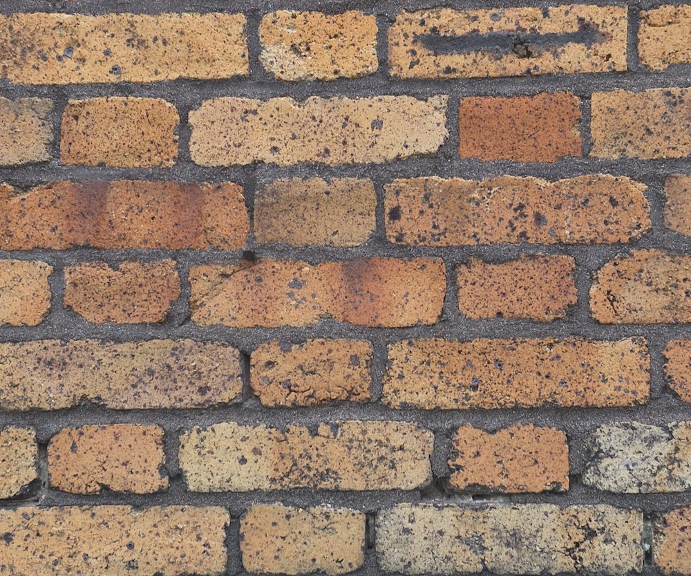 Moisture saturated brick facade causing deterioration and heat loss