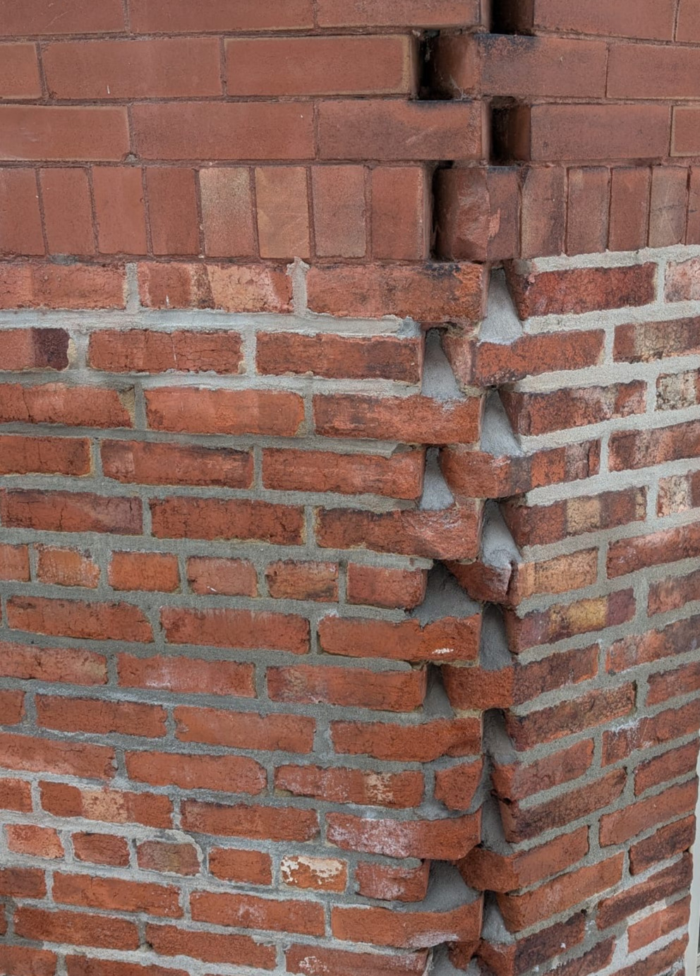 Close up of wet brick facade showing moisture absorption and energy loss