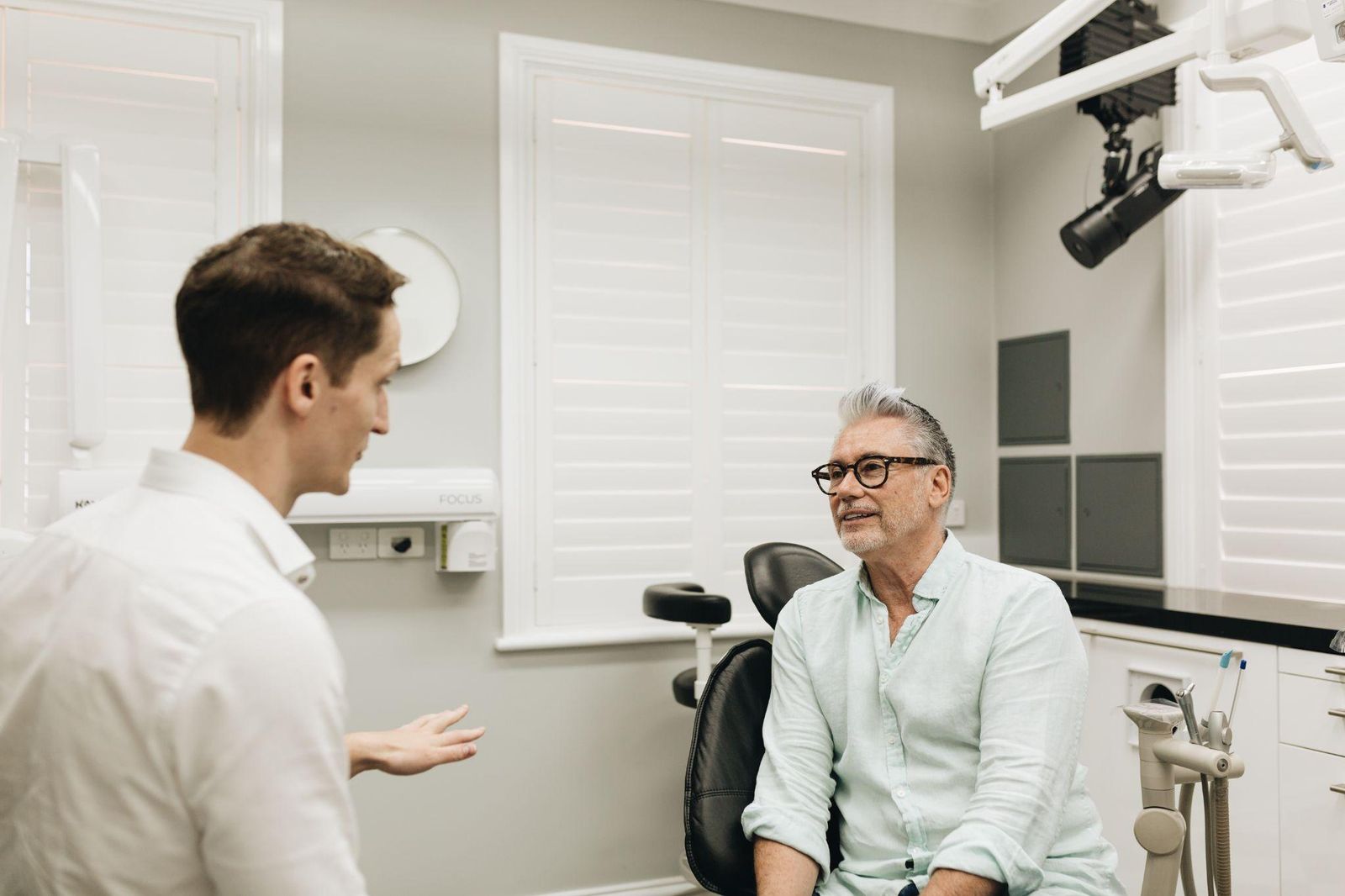 Dr Andrew Peterson discussing veneer options with a patient in Penrith.