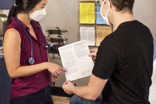 In this 2020 photograph, captured inside a clinical setting, a health care provider and patient, consult on influenza vaccine options. The best way to prevent seasonal flu illness, is to get vaccinated every year. Centers for Disease Control and Prevention (CDC) recommends everyone 6-months of age and older get a flu vaccine every season. There are many vaccine options to choose from, but the most important thing, is for all people 6-months and older, get an influenza vaccine every year.