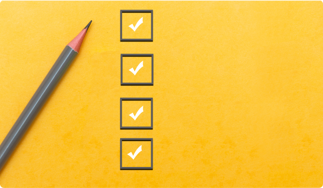 A grey pencil lying next to a column of four grey checkboxes with white ticks on a yellow background