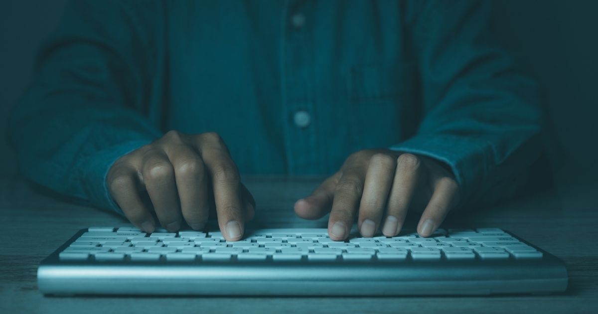 Hands typing on a keyboard