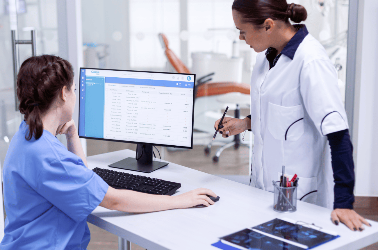 Medical practice reception with booking software on the screen