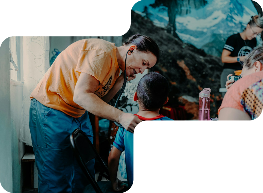 Healthcare worker uses a stethoscope to listen to a young boy's back during a checkup indoors.