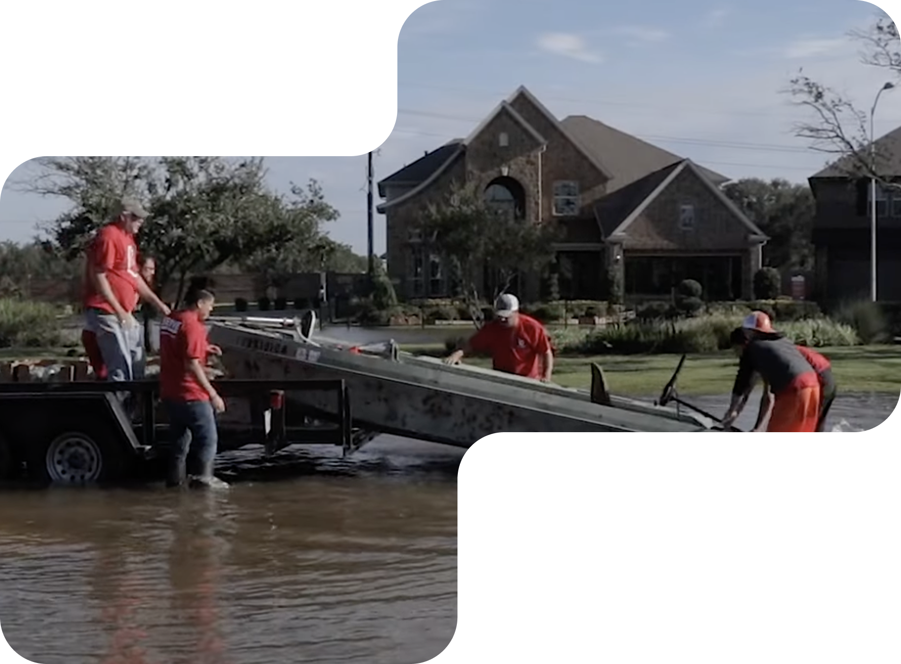 Rescuers in orange life vests navigate a raft through floodwater in an urban area.