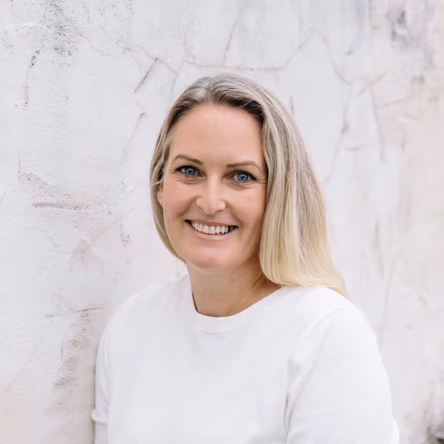 Headshot of Erin Whale in a white t-shirt.