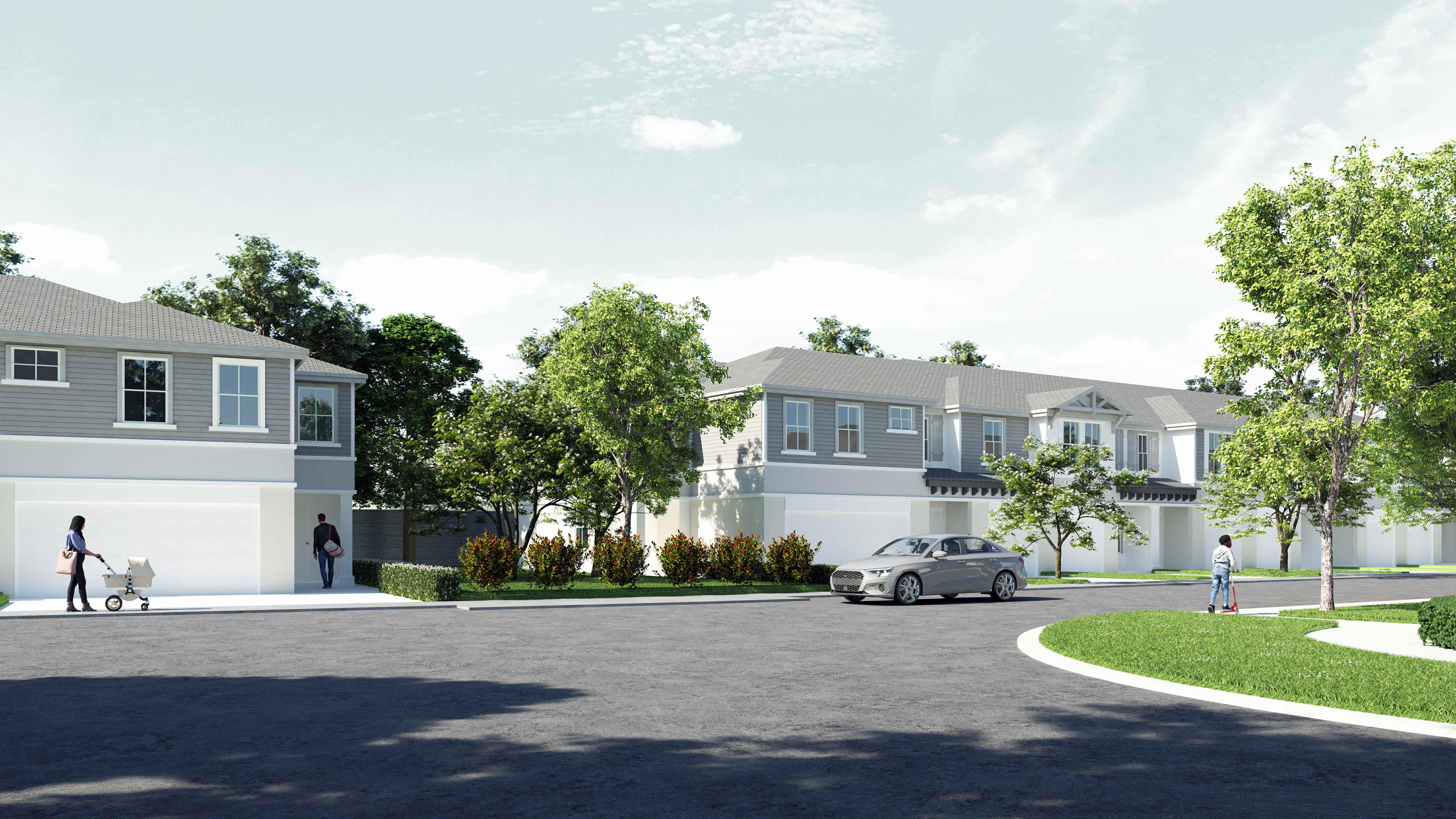 Street view of modern two-story houses with a car parked on the road and people walking nearby, surrounded by green trees and shrubs.