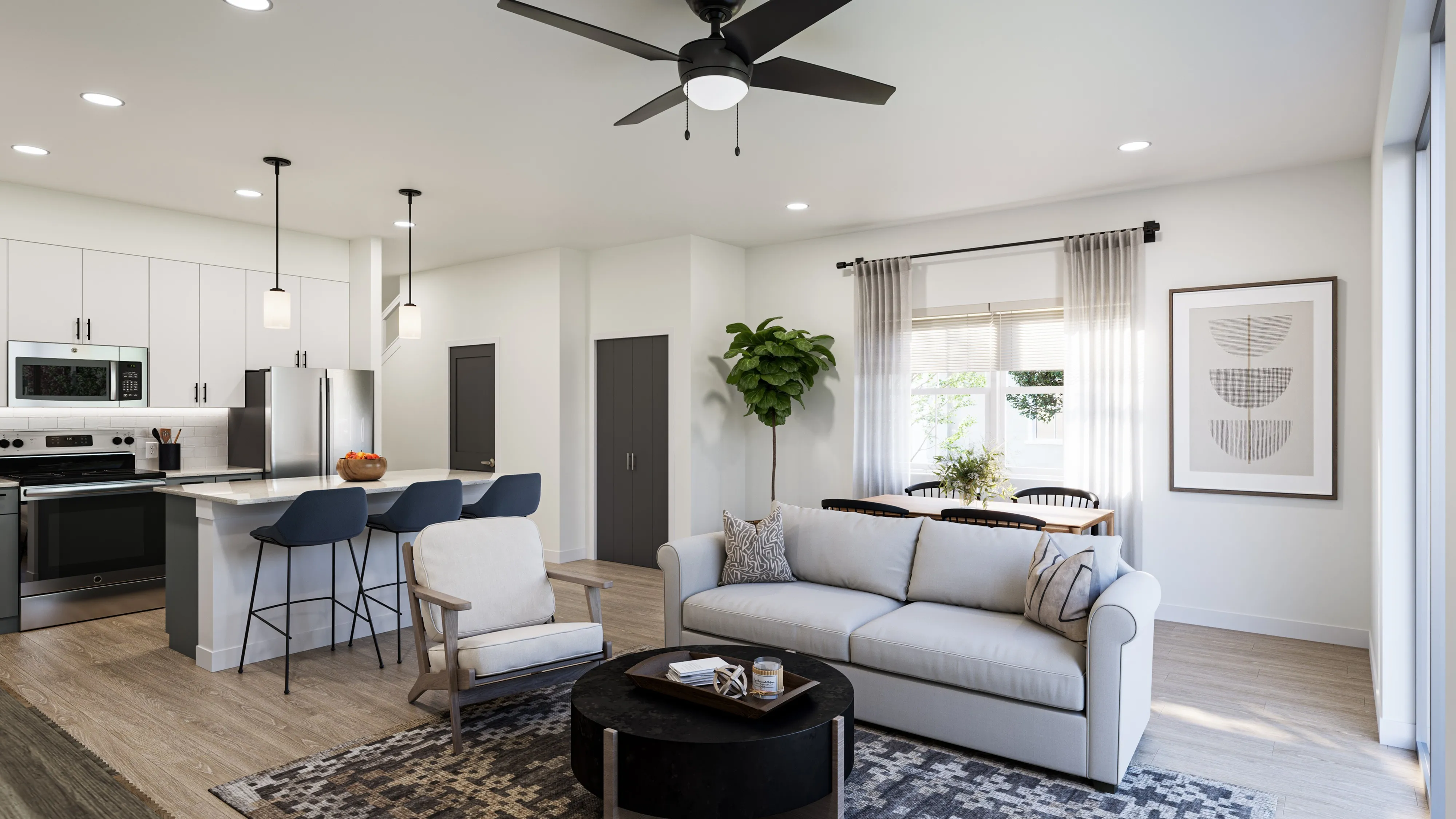 Modern open-concept living room and kitchen with a gray sofa, armchair, black round coffee table, kitchen island with three bar stools, and dining area by a window.