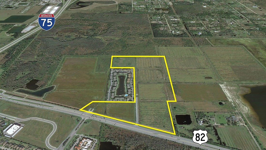 Aerial view of a large land plot outlined in yellow between Interstate 75 and U.S. Route 82, featuring fields, a pond, and residential area in a rural setting.