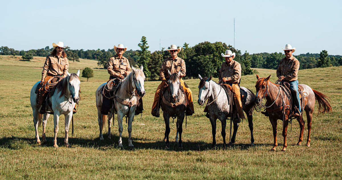 Timber Creek Ranch riders gathered on horseback in an East Texas pasture