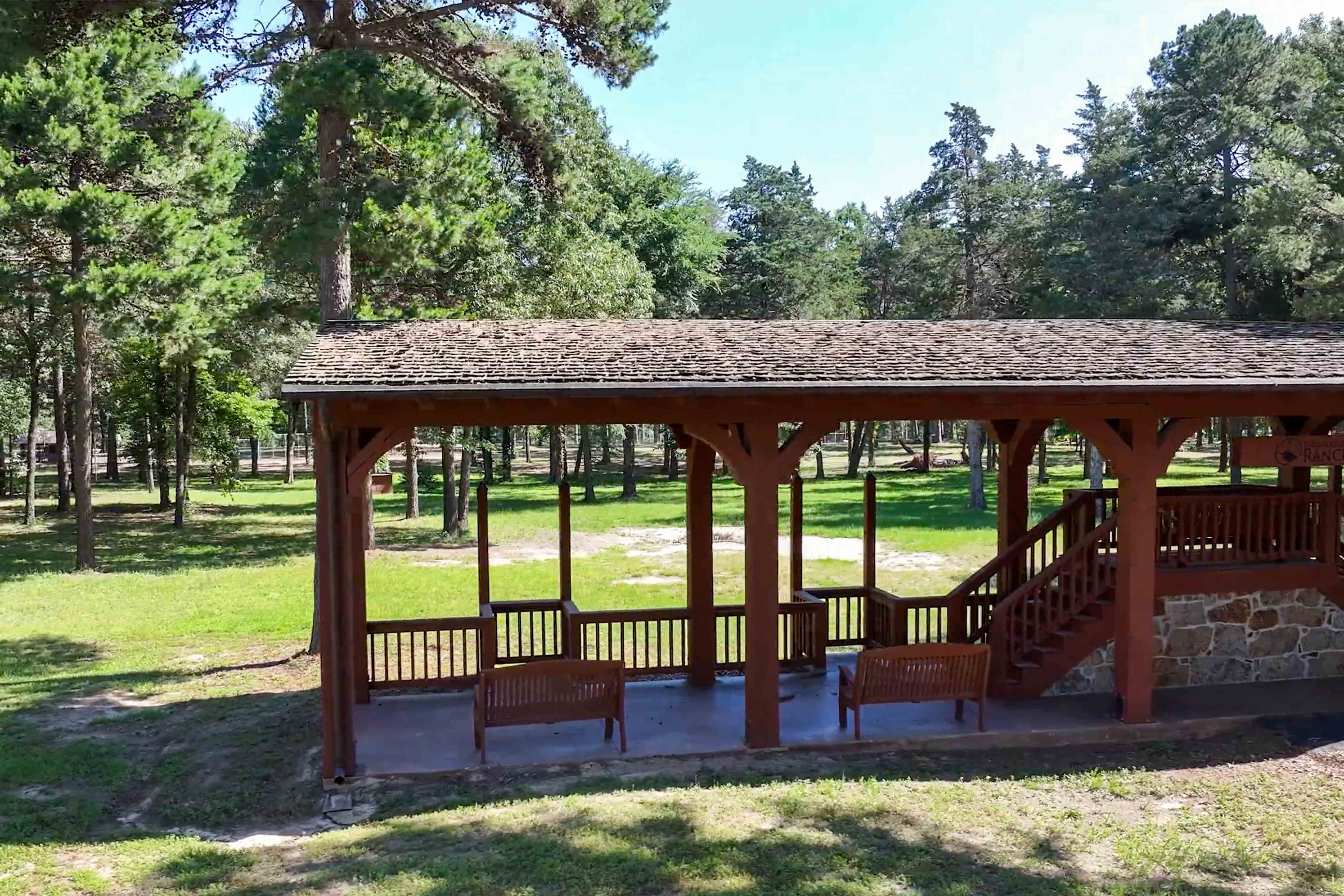 Open-air pavilion among the trees at Timber Creek Ranch