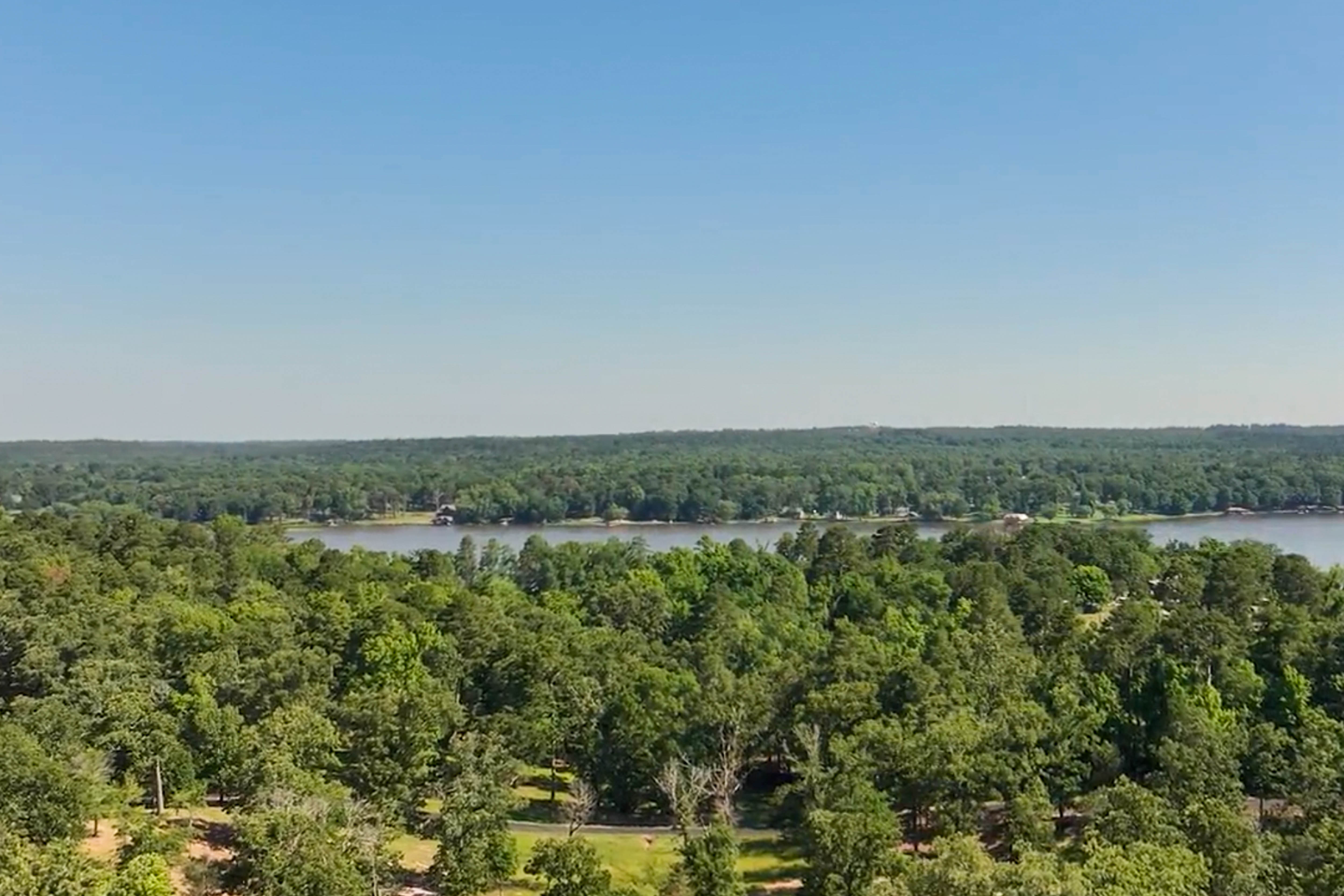 Aerial view of the lake and wooded Timber Creek acreage