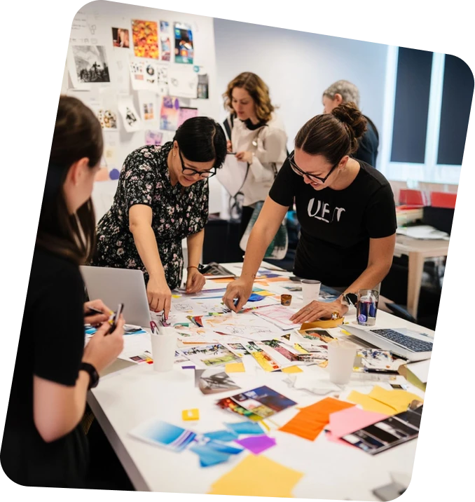 A group of people standing around a table.