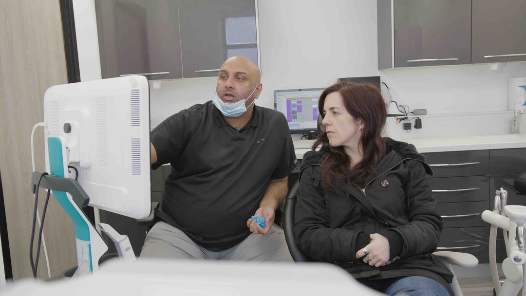 Lotus Dental Studio clinician explaining a dental implant treatment plan to a patient in Llanelli