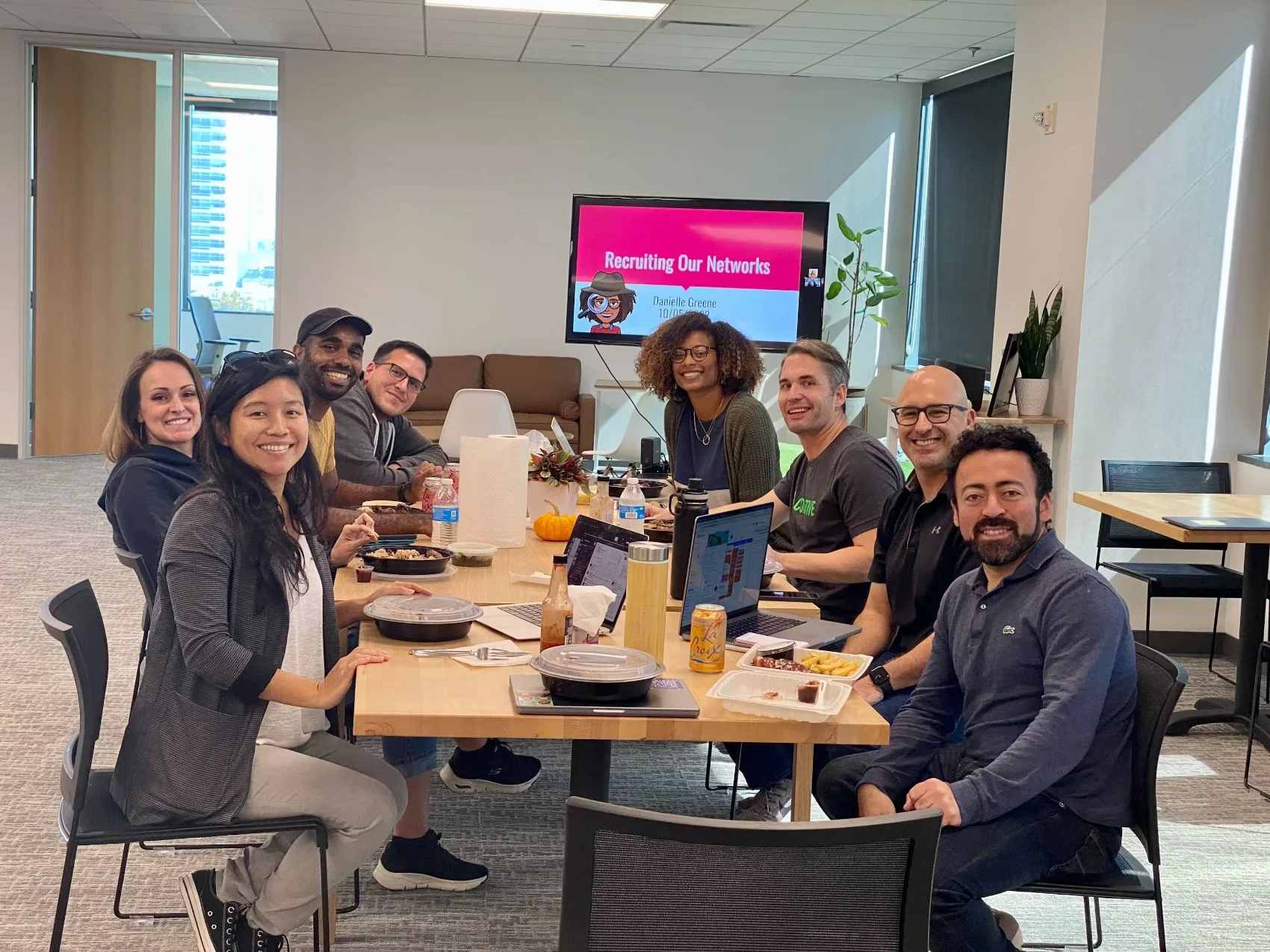 Coactive team members eating lunch together around a large table