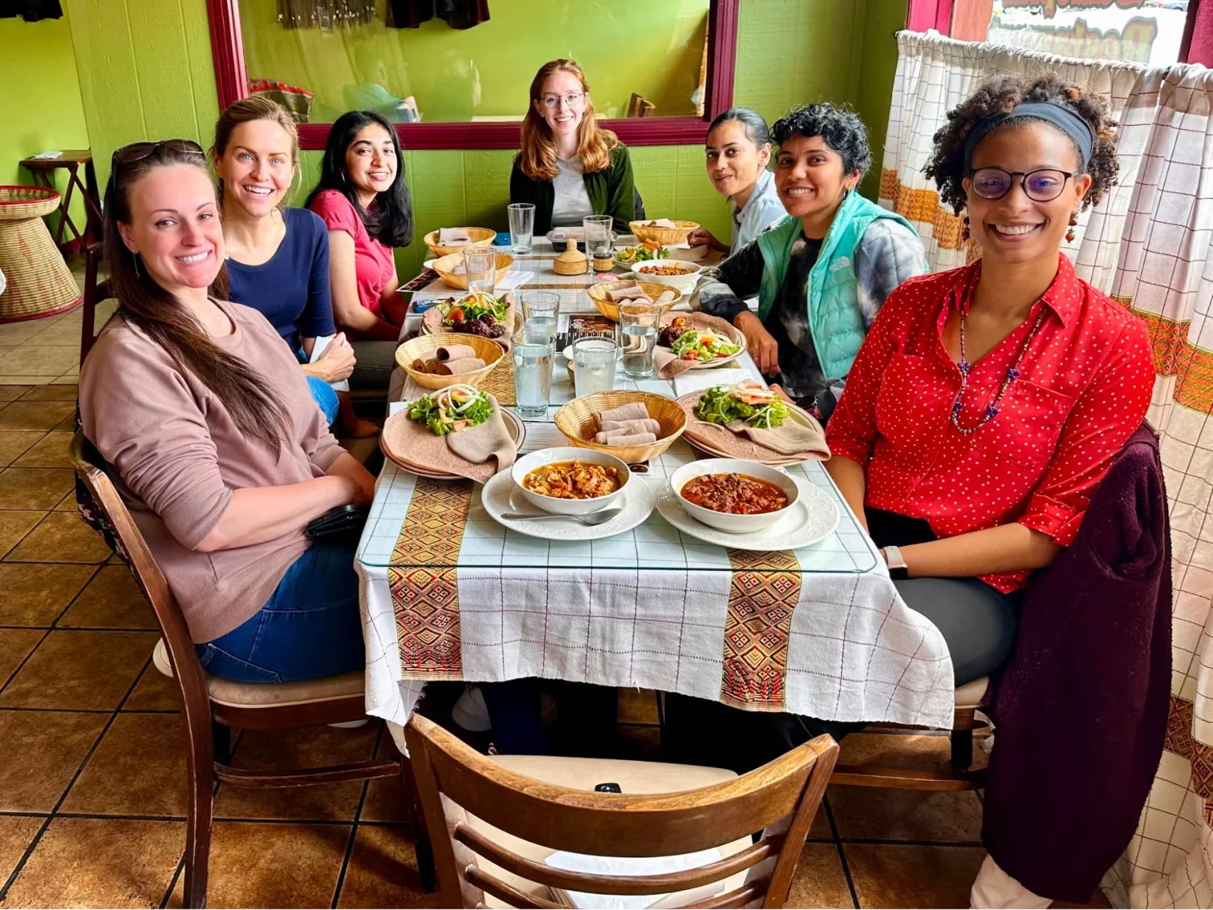 Mehul enjoying Ethiopian food with Coactive teammates at a "women at Coactive lunch"