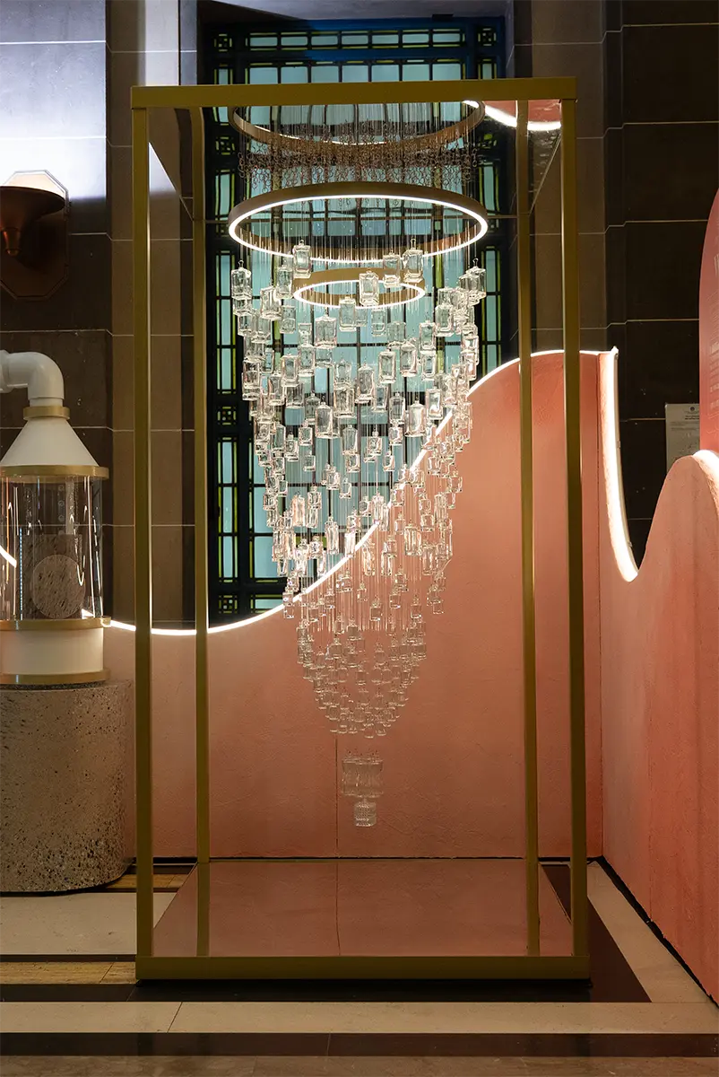A chandelier constructed from used fragrance bottles