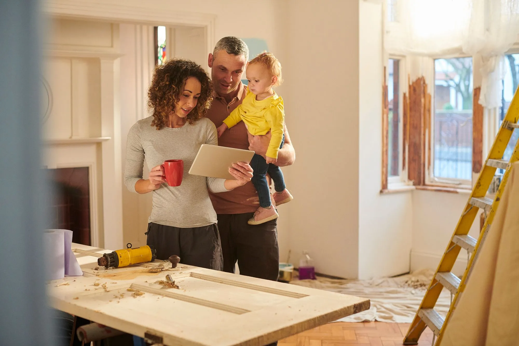 A family in a house looking at architect drawings
